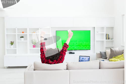 Image of young man in bathrobe enjoying free time