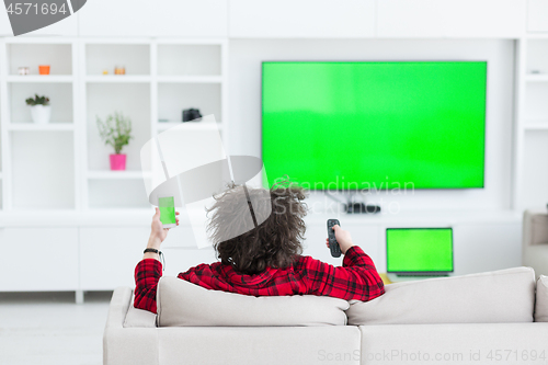 Image of young man in bathrobe enjoying free time