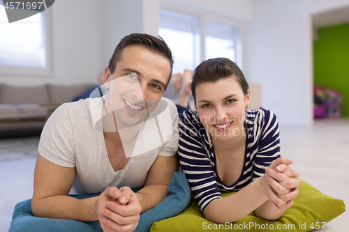 Image of couple lying on the floor at home
