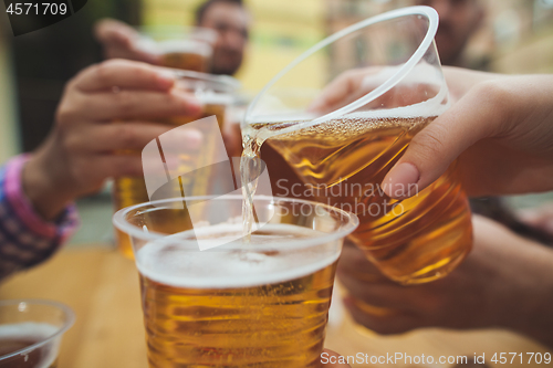 Image of The group of friends enjoying drink at outdoor bar