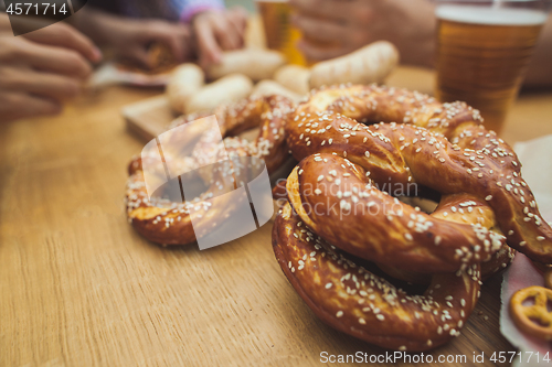 Image of Boiled white sausages, served with beer and pretzels. Perfect for Octoberfest. Natural wooden background.