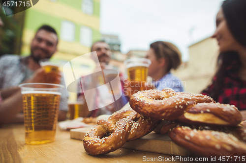 Image of The group of friends enjoying drink at outdoor bar