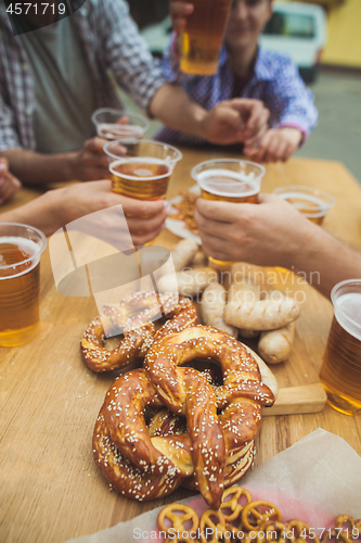 Image of Boiled white sausages, served with beer and pretzels. Perfect for Octoberfest. Natural wooden background.