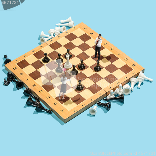 Image of Business decision making concept. Miniature people : small businessman figure standing and walking on chessboard with chess pieces