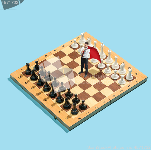 Image of Business decision making concept. Miniature people : small businessman figure standing and walking on chessboard with chess pieces