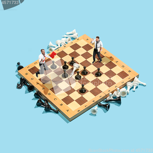 Image of Business decision making concept. Miniature people : small businessman figure standing and walking on chessboard with chess pieces