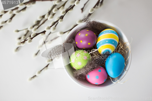 Image of colored easter eggs and pussy willow branches