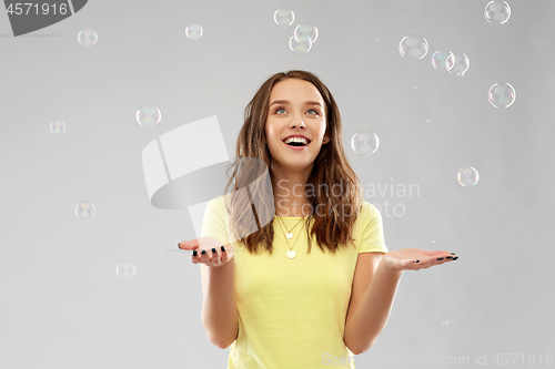 Image of young woman or teenage gir with soap bubbles