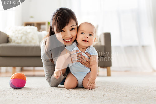 Image of happy young mother with little baby at home