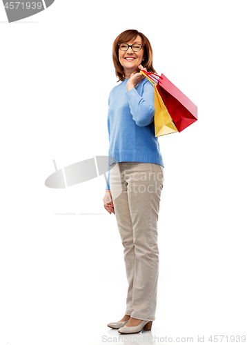 Image of senior woman with shopping bags isolated on white