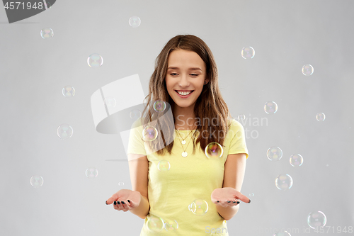 Image of young woman or teenage gir with soap bubbles