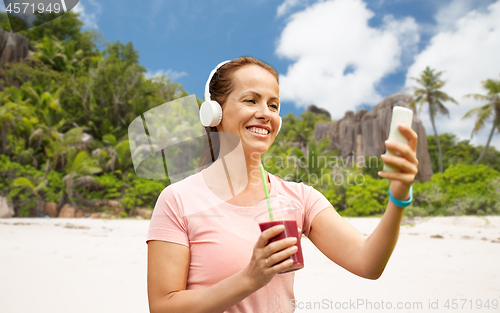Image of woman with smartphone and shake listening to music
