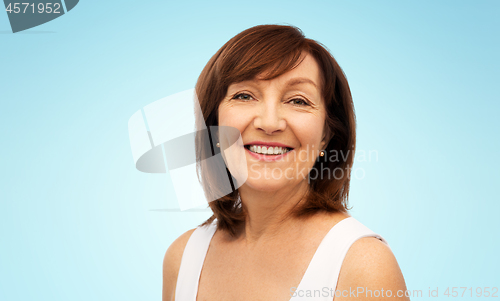 Image of portrait of smiling senior woman over white