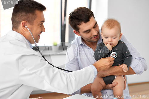 Image of father with baby and doctor at clinic