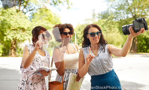 Image of women with map travelling and recording video blog