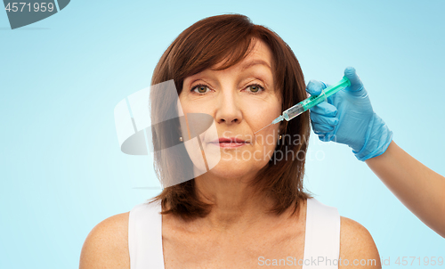 Image of senior woman and surgeon hand with syringe