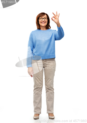 Image of happy senior woman in glasses showing ok hand sign