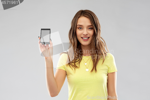 Image of young woman or teenage girl holding smartphone