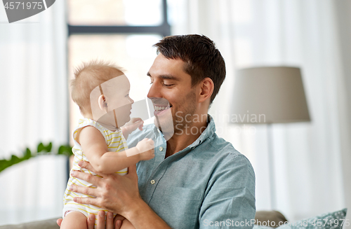 Image of father with little baby daughter at home