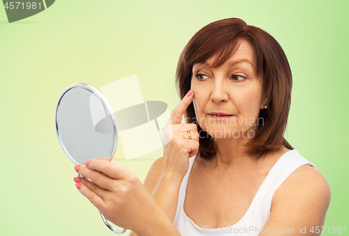 Image of portrait of smiling senior woman with mirror