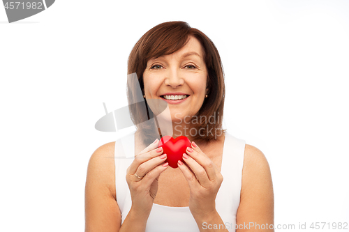 Image of portrait of smiling senior woman holding red heart