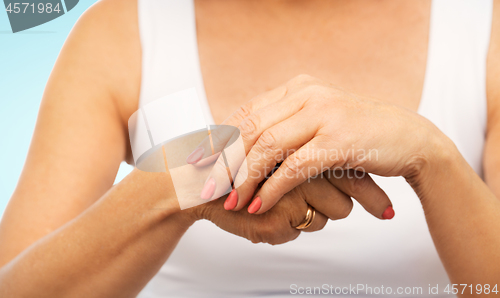 Image of close up of senior woman hands with manicure