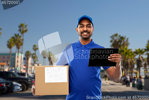 Image of indian delivery man with tablet pc and parcel box