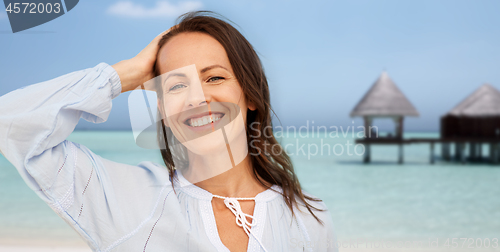 Image of happy smiling woman on summer beach