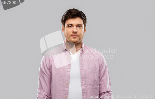 Image of young man over grey background