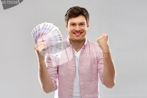 Image of happy young man with fan of euro money