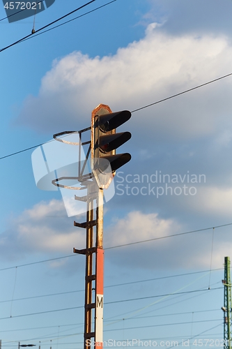 Image of Railway signal light on a rusty post