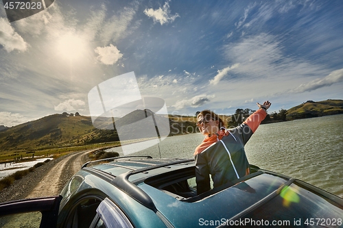 Image of Car journey enjoying sunroof in the countryside