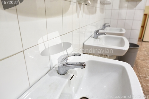 Image of Taps an basins in a row