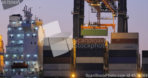 Image of Loading containers on a ship at dawn