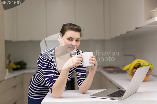 Image of woman drinking coffee enjoying relaxing lifestyle