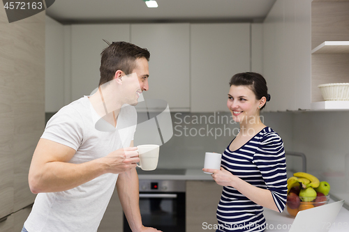 Image of couple with laptop computer enjoying morning