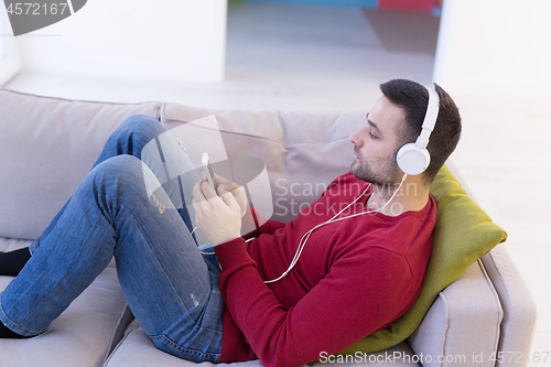 Image of man enjoying music through headphones