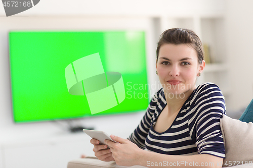 Image of woman on sofa using tablet computer