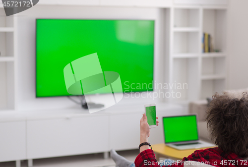 Image of young man in bathrobe enjoying free time