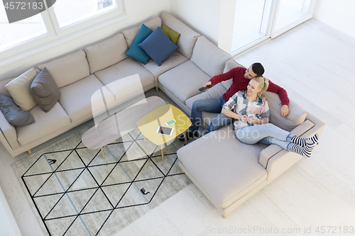 Image of Young couple on the sofa watching television