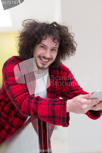 Image of young freelancer using tablet computer