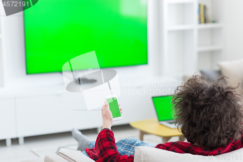 Image of young man in bathrobe enjoying free time