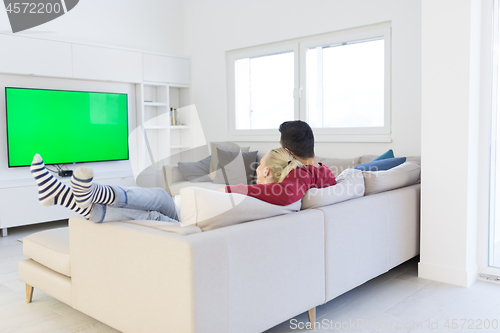 Image of Young couple on the sofa watching television