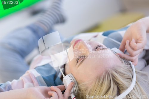 Image of girl enjoying music through headphones