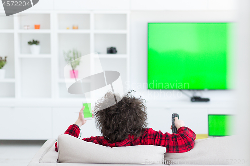 Image of young man in bathrobe enjoying free time