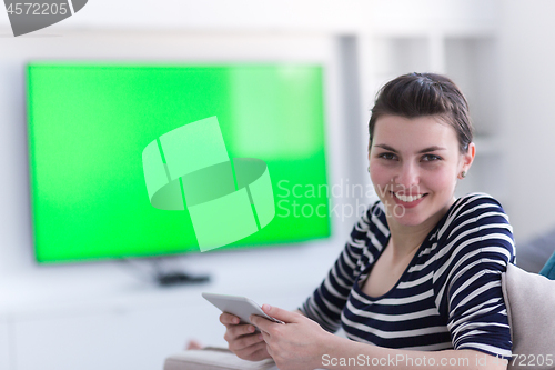 Image of woman on sofa using tablet computer