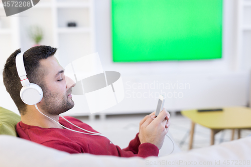 Image of man enjoying music through headphones