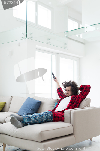 Image of young man in bathrobe enjoying free time