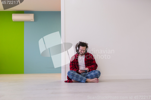 Image of young man enjoying music through headphones