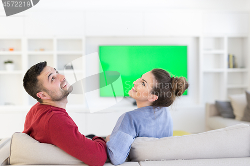 Image of Young couple on the sofa watching television